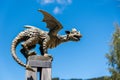 Profile view of bronze dragon statue on pole isolated on blue sky