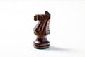 Carved Wooden Knight Chess Piece on White in Profile Royalty Free Stock Photo