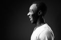 Profile view portrait of young African man smiling in black and white Royalty Free Stock Photo