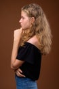 Profile view portrait of young beautiful blonde teenage girl thinking Royalty Free Stock Photo