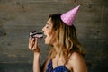 Profile view of pretty woman eating piece of birthday cake Royalty Free Stock Photo