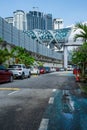 Profile view of the Saloma link bridge with a local pedestrian walking and crossing it