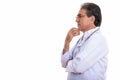 Profile view of senior Persian man doctor thinking