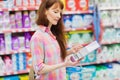 Profile view of woman with shopping basket holding product Royalty Free Stock Photo