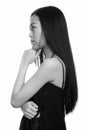 Profile view of young Asian teenage girl thinking Royalty Free Stock Photo