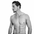 Profile view of young handsome man thinking shirtless isolated against white background Royalty Free Stock Photo