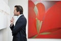 Profile view of a young man in a art art gallery