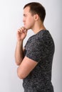 Profile view of young muscular man thinking against white backgr Royalty Free Stock Photo