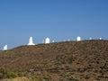 Profile of white telescopes under blue sky. Teide Astrophysical Observatory. Observational set of the Institute of Astrophysics.