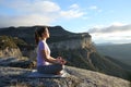 Profile of a woman doing yoga in the top of a cliff Royalty Free Stock Photo