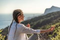 Profile of a woman doing yoga in the top of a cliff in the mountain. Woman meditates in yoga asana Padmasana Royalty Free Stock Photo