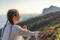 Profile of a woman doing yoga in the top of a cliff in the mountain. Woman meditates in yoga asana Padmasana Royalty Free Stock Photo