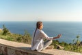 Profile of a woman doing yoga in the top of a cliff in the mountain. Woman meditates in yoga asana Padmasana Royalty Free Stock Photo