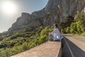 Profile of a woman doing yoga in the top of a cliff in the mountain. Woman meditates in yoga asana Padmasana Royalty Free Stock Photo