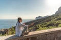 Profile of a woman doing yoga in the top of a cliff in the mountain. Woman meditates in yoga asana Padmasana Royalty Free Stock Photo