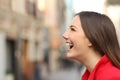 Profile of a woman face laughing happy in the street