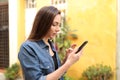 Profile of a woman using smart phone outdoors