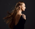 Profile of young beautiful woman with long silky straight flying hair in black body with eyes closed Royalty Free Stock Photo