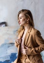 Profile of a young dreamy girl in a light beige suit
