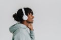 Profile of young man smiling while listening music with headphones isolated Royalty Free Stock Photo