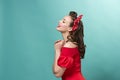 Beautiful young woman with pinup make-up and hairstyle. Studio shot on pastel background Royalty Free Stock Photo