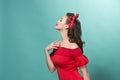 Beautiful young woman with pinup make-up and hairstyle. Studio shot on pastel background Royalty Free Stock Photo