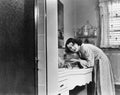 Profile of a young woman washing her hands in the bathroom sink Royalty Free Stock Photo