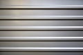 Profiled galvanized sheet with horizontal stripes. Partial lighting from above