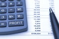 Profit button on calculator, pen and report Royalty Free Stock Photo