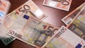 Profit. 50 Euro. Money falls on the table. 50 Euro banknotes. Artistic dark background.