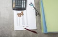 Profit and loss concept image of a pen, calculator and coins on financial documents Royalty Free Stock Photo