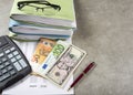 Profit and loss concept image of a pen, calculator and coins on financial documents. Royalty Free Stock Photo