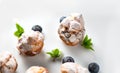 Profiterole or cream puff with filling, powdered with sugar, with berries, isolated on white background