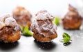 Profiterole or cream puff with filling, powdered sugar topping with berries, isolated on white background