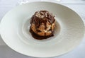 A Profiterole, French choux pastry covered in a rich chocolate sauce