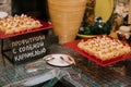 Profiteroles with salted caramel on a red platter. Buffet. Buffet table with cold snacks. Banquet or wedding celebration