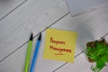 Program Management write on sticky notes isolated on Wooden Table