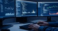 Programmer analyzes data on multiple monitors with charts and code for cybersecurity Royalty Free Stock Photo