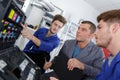 Programmer apprentices fixing continuous ink supply system Royalty Free Stock Photo