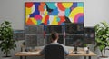 Programmer coding on an extensive multi-monitor setup in a modern office Royalty Free Stock Photo