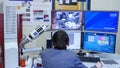 Programmer configures the computer for bitcoin mining. Programmers are watching the bitcoin exchange rate. Man sits at