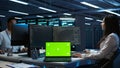 Programmer in data center maintaining databases using chroma key notebook Royalty Free Stock Photo