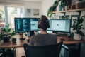 Focused Programmer Working on Dual Monitors in a Home Office