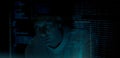 Programmer or Developer working in dark room with computer code reflected on their monitor Royalty Free Stock Photo