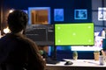 Programmer doing software debugging on green screen PC at home