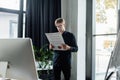 Programmer in eyeglasses holding paper near