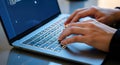 Person hands typing on laptop keyboard with code on screen for concept of programming, software development, or cybersecurity Royalty Free Stock Photo