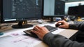 Programmer hands typing code on keyboard while working with software on desktop computers Royalty Free Stock Photo