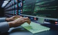 Programmer hands typing on illuminated keyboard in a data center environment Royalty Free Stock Photo