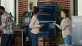 Programmer holding digital tablet analyzing code on wall screen tv while colleague is looking for errors Royalty Free Stock Photo